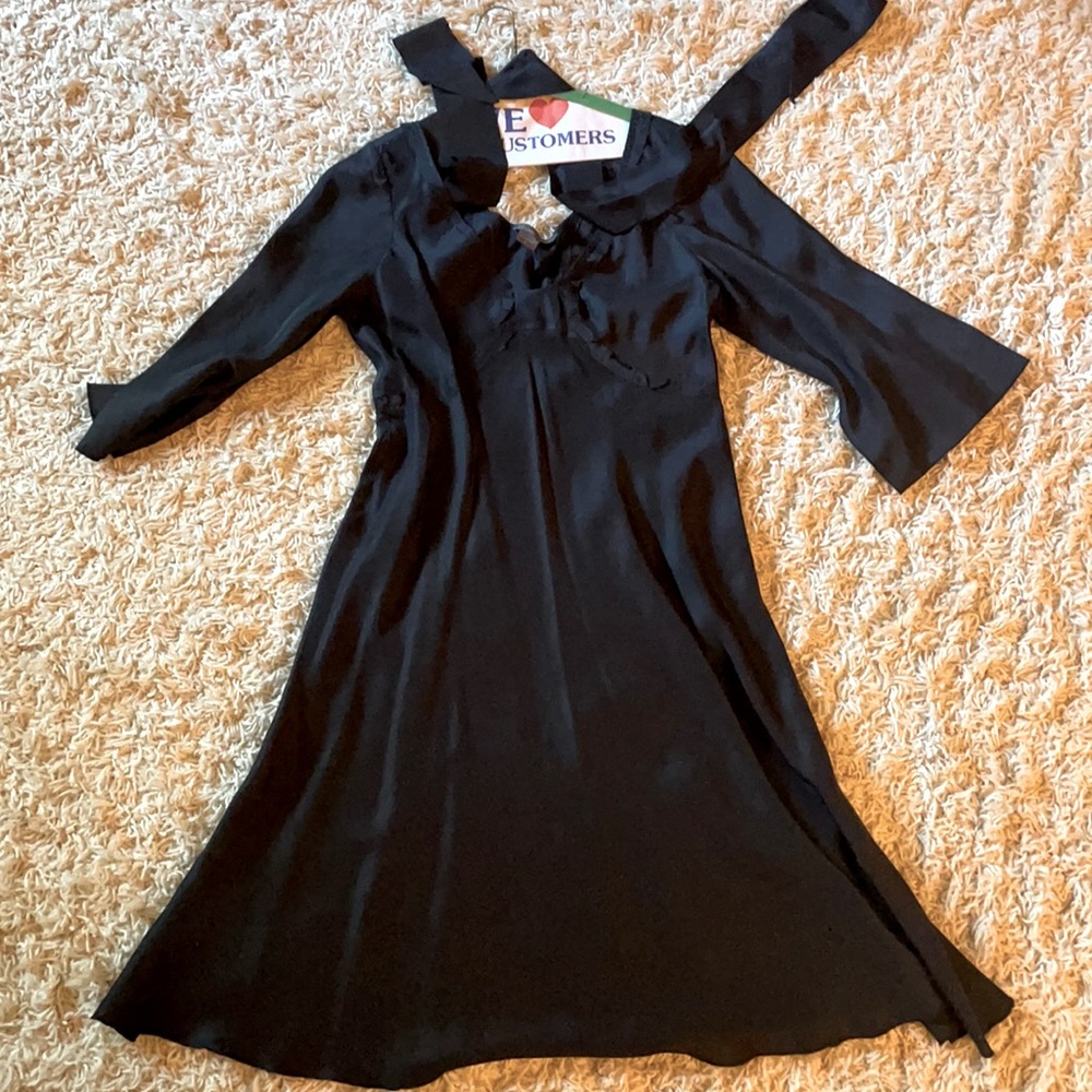 Black silk dress with tie around waist with sleeves.